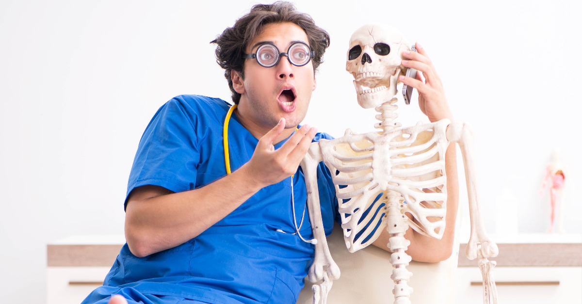 doctor playing with a skeleton
